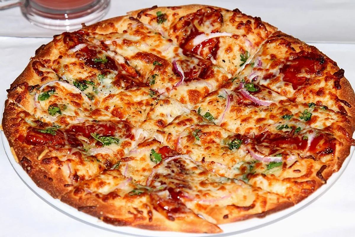 BBQ chicken pizza with red onion cilantro and melted smoked Gouda