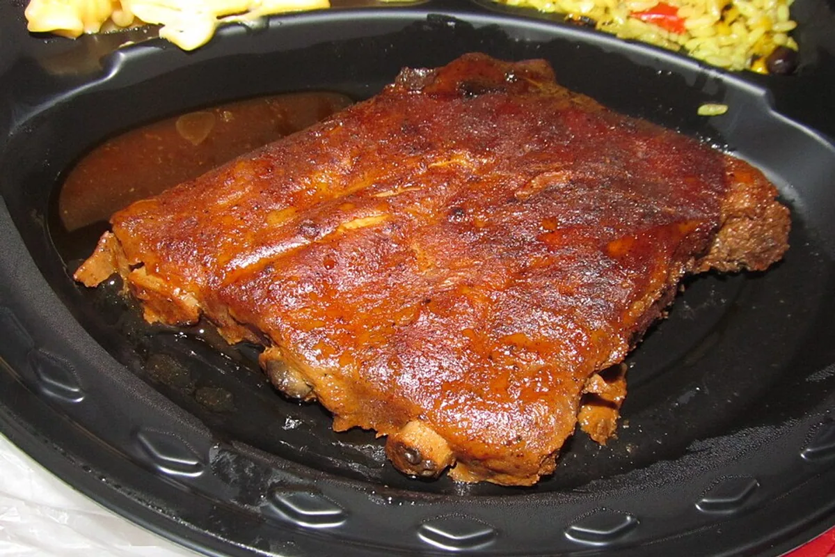 Close-up of a full slab of pork ribs with glossy barbecue glaze