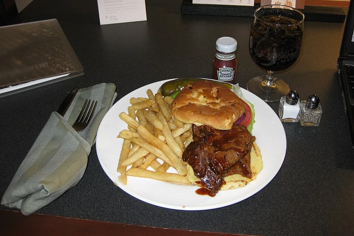 Kansas City barbecue brisket sandwich with sauce and french fries