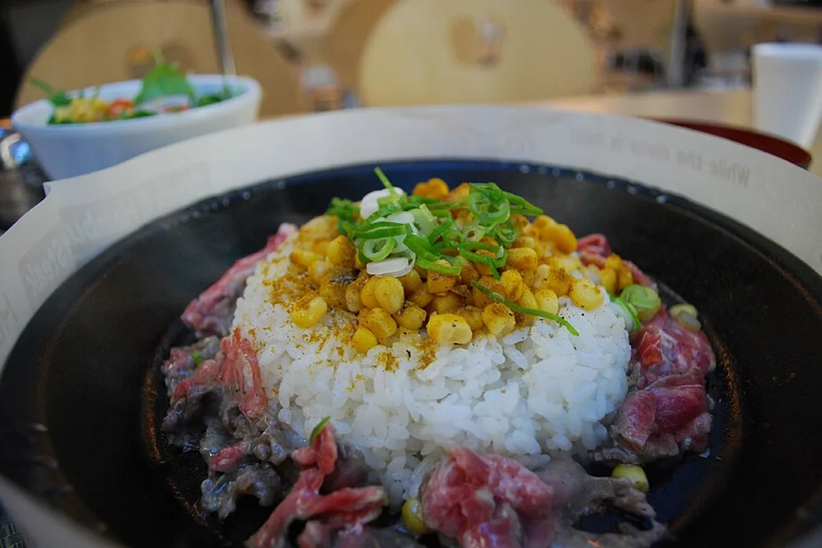 Beef pepper curry rice with corn scallions and glossy sauce