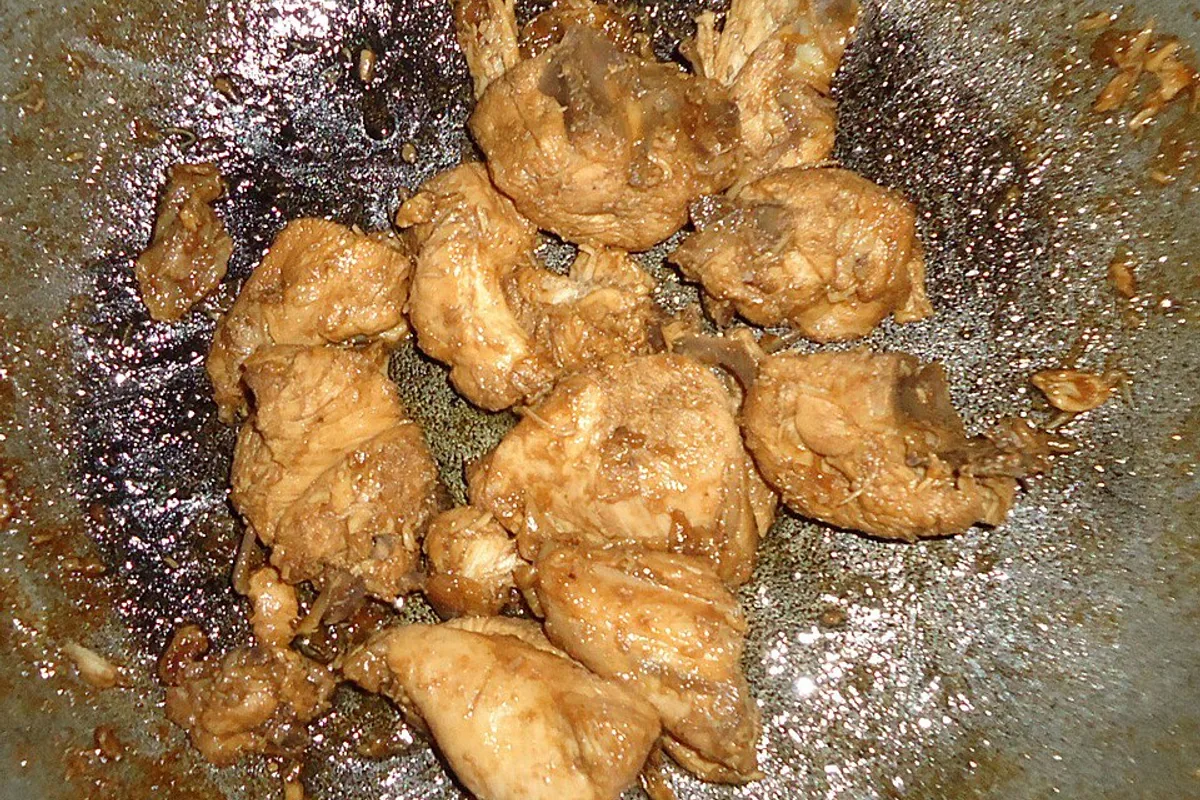 Browned Filipino chicken adobo pieces in a glossy garlic vinegar soy sauce