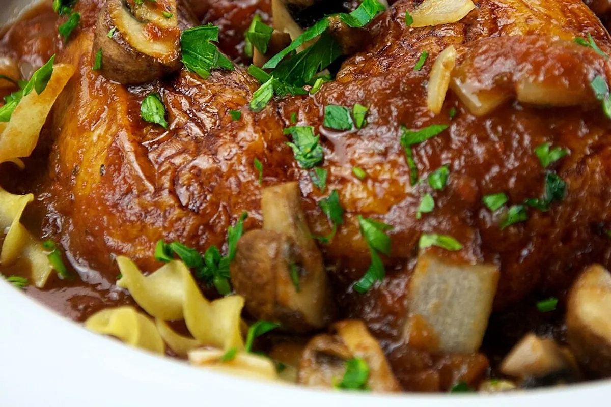 Chicken cacciatore in tomato mushroom sauce over egg noodles
