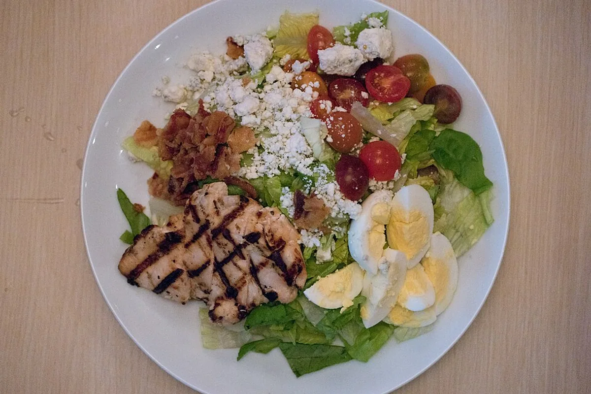 Chicken Cobb salad with grilled chicken egg bacon avocado tomato blue cheese and lettuce