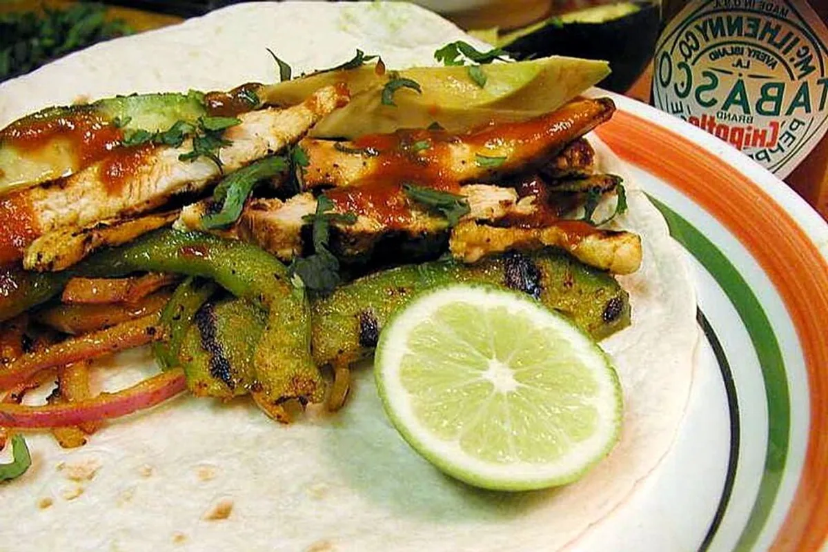 Grilled chicken fajita strips with peppers onions and fresh lime