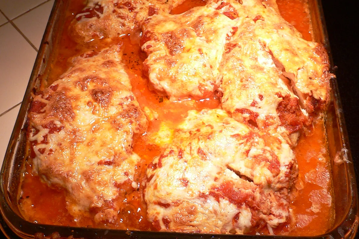 Baked chicken Parmesan cutlets with tomato sauce and melted cheese