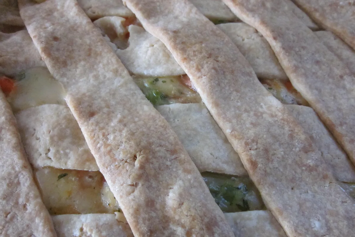 Cooked chicken pot pie with a woven golden crust