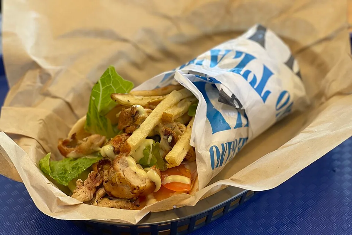 Chicken souvlaki pita wrap with lettuce tomato and creamy sauce