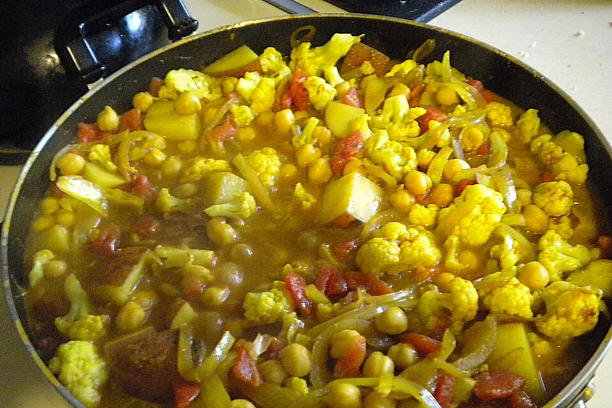Golden curried cauliflower and chickpea stew with tomato and onion