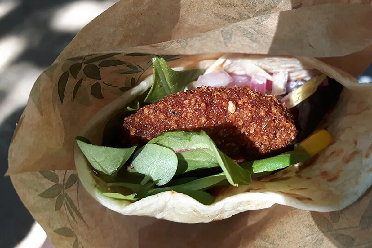 Falafel pita wrap with spinach pickled vegetables and tahini sauce