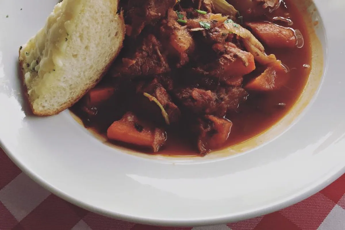 Red beef and vegetable stew served with bread