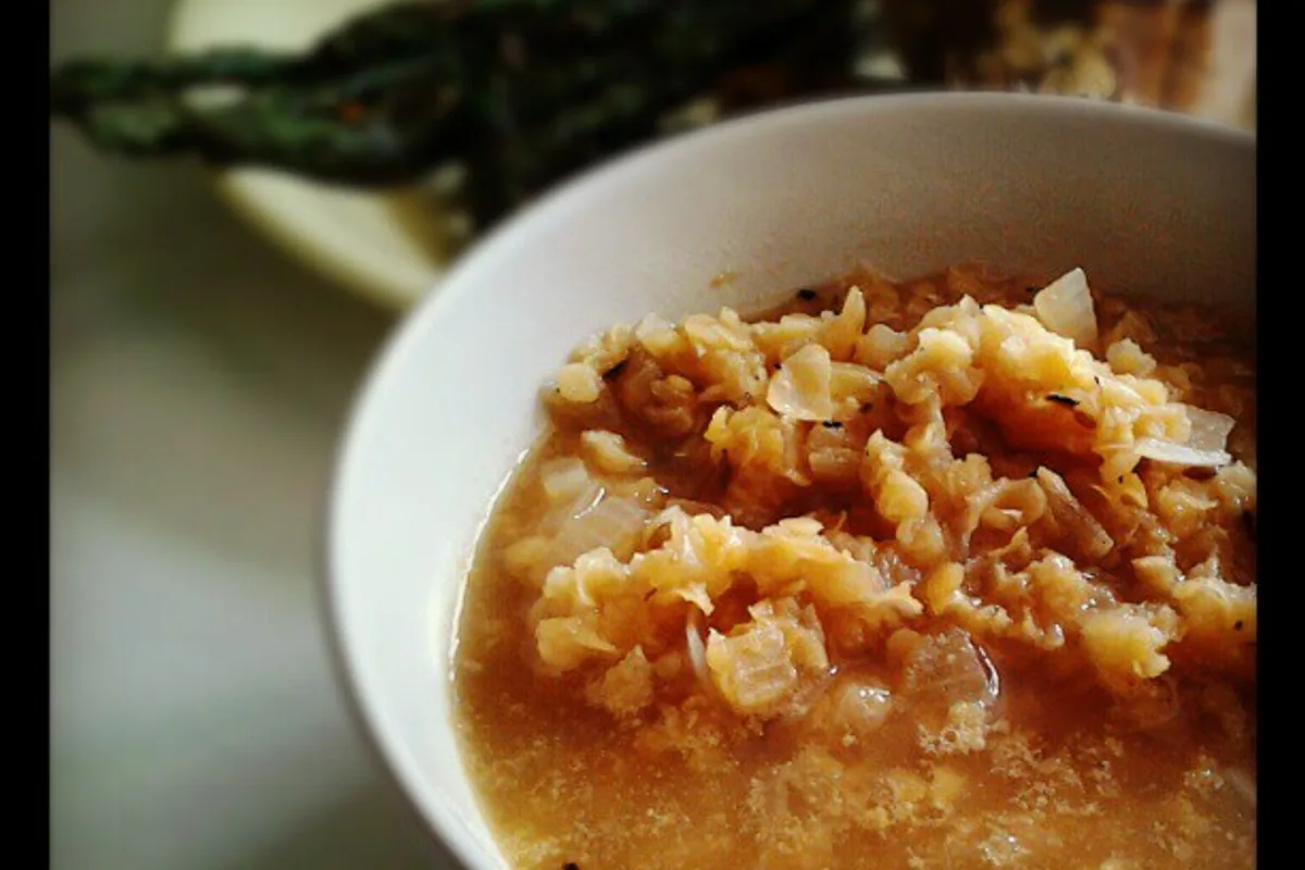 Thick red curried lentil soup in a white bowl