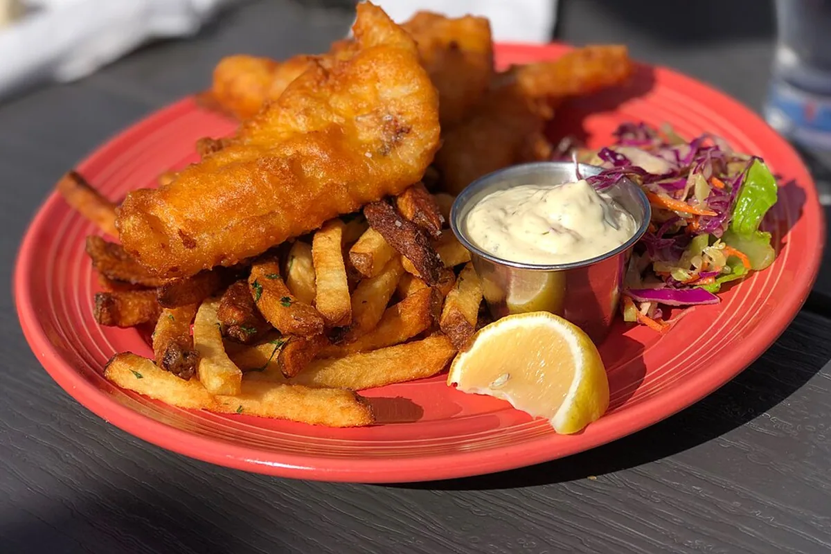 Crisp battered fish fillets with fries lemon and tartar sauce