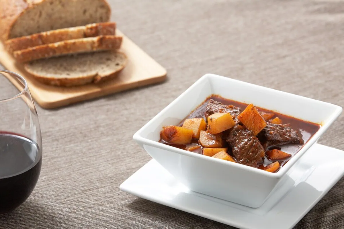 Hungarian beef goulash with paprika broth potatoes carrots and peppers