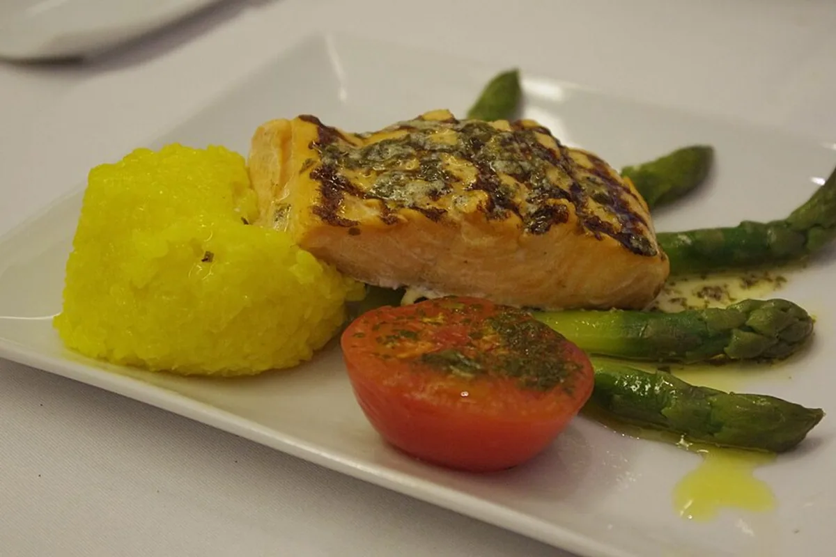 Grilled salmon with asparagus saffron risotto herbed tomato and lemon butter