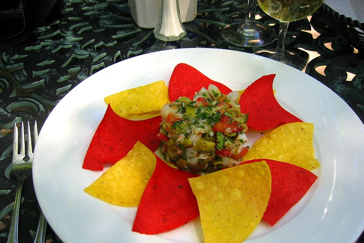 Lobster and shrimp ceviche surrounded by red and yellow tortilla chips