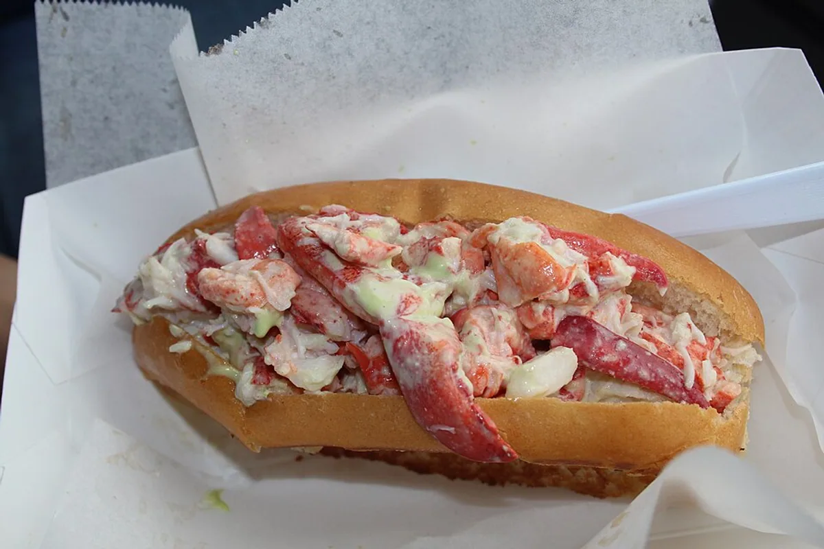 Maine lobster roll filled with lobster salad lettuce and lemon