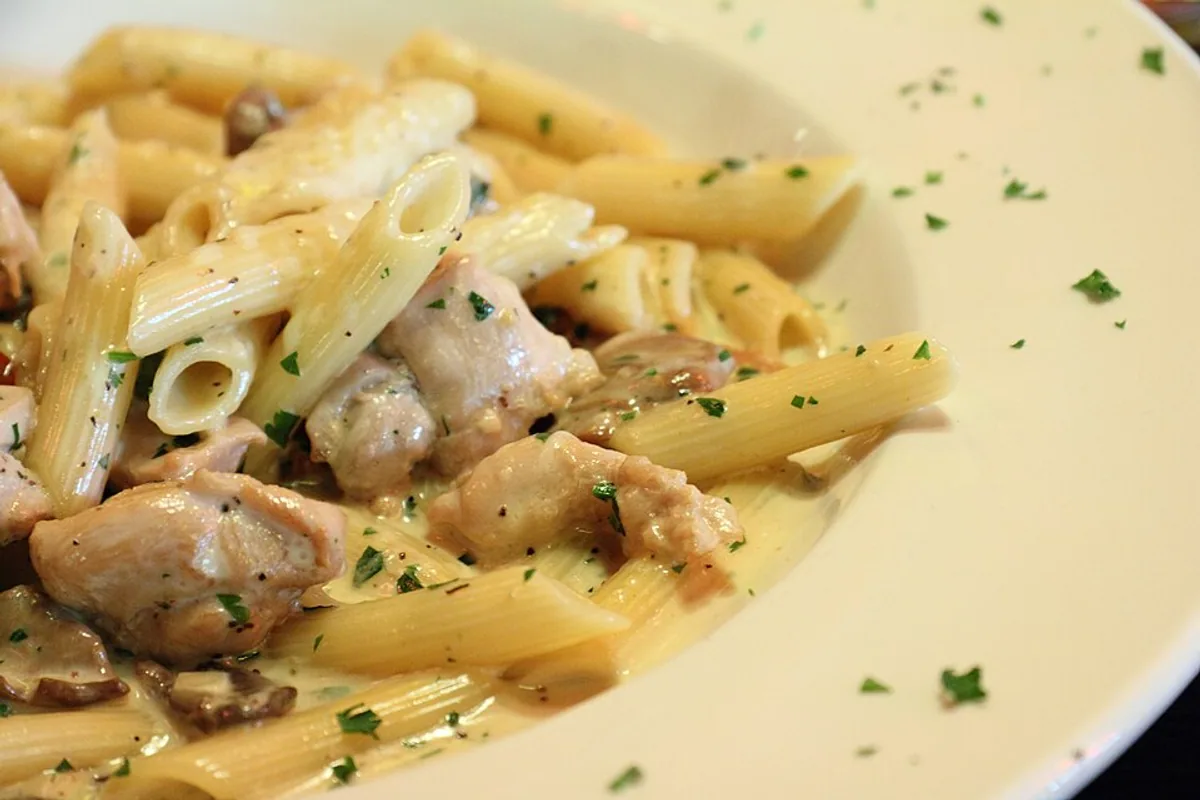 Smoked chicken pesto penne with mushrooms cream sauce and parsley