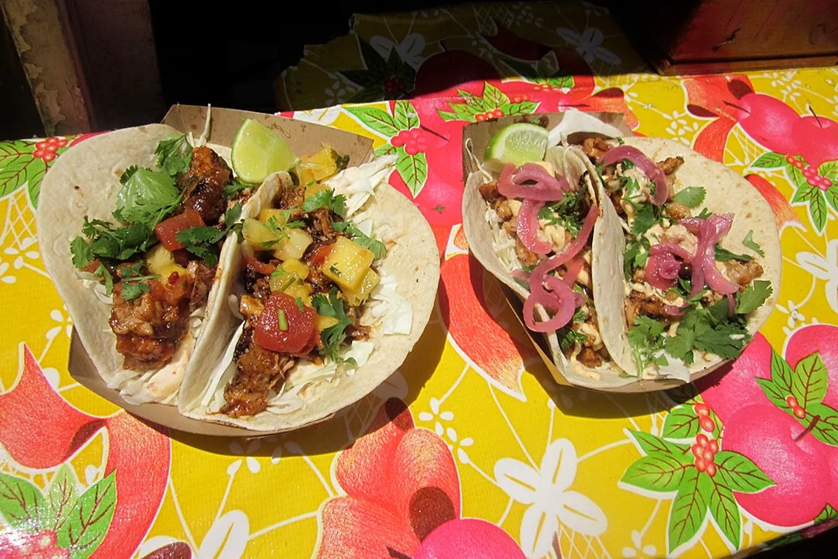BBQ pork and spicy chicken tacos with cabbage slaw and herbs