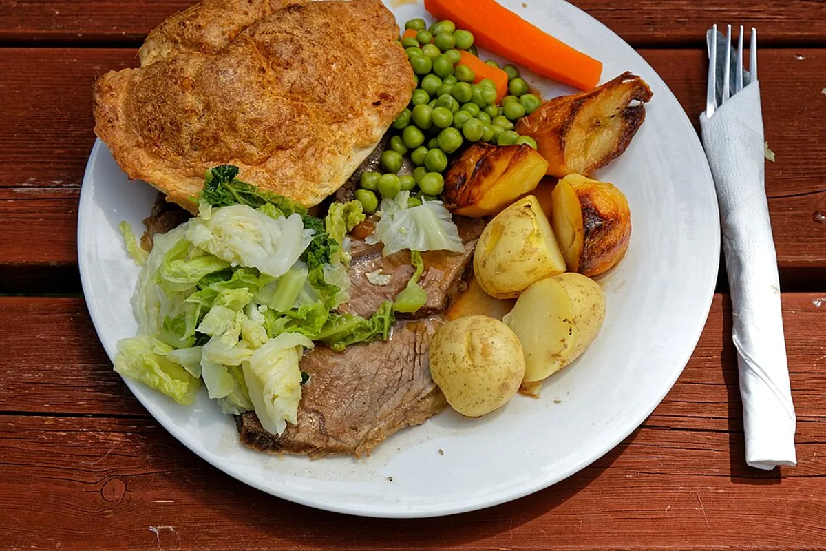 Roast beef dinner with Yorkshire pudding peas carrots and roasted potatoes