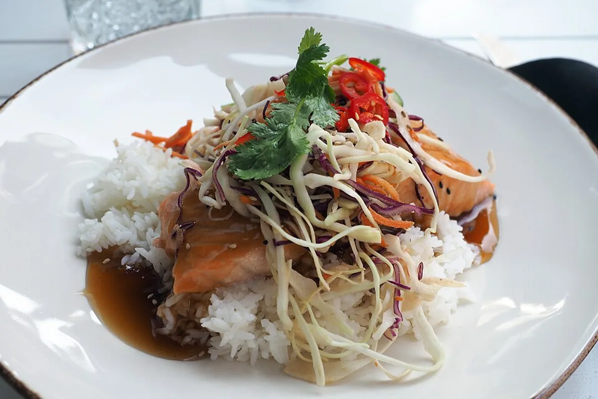 Teriyaki-glazed salmon with steamed rice cabbage-carrot slaw and herbs