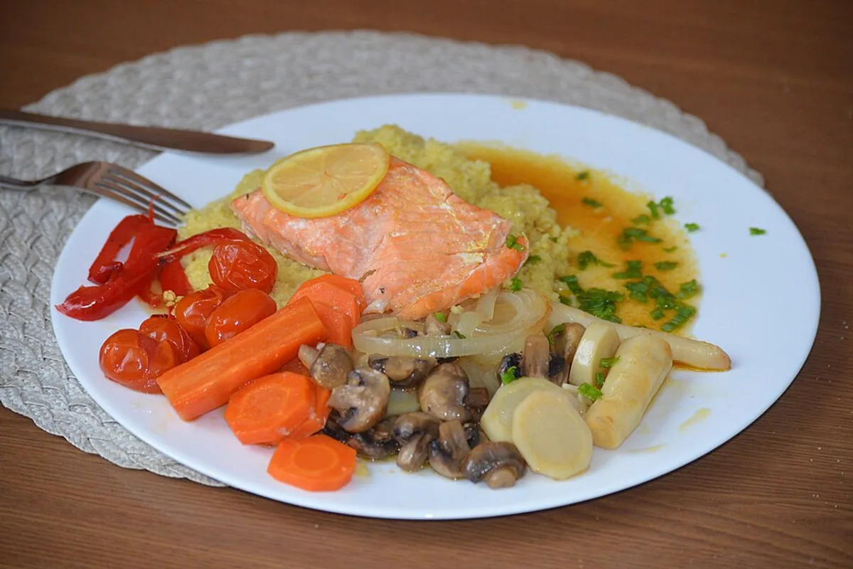 Baked salmon with couscous carrots mushrooms and mixed vegetables