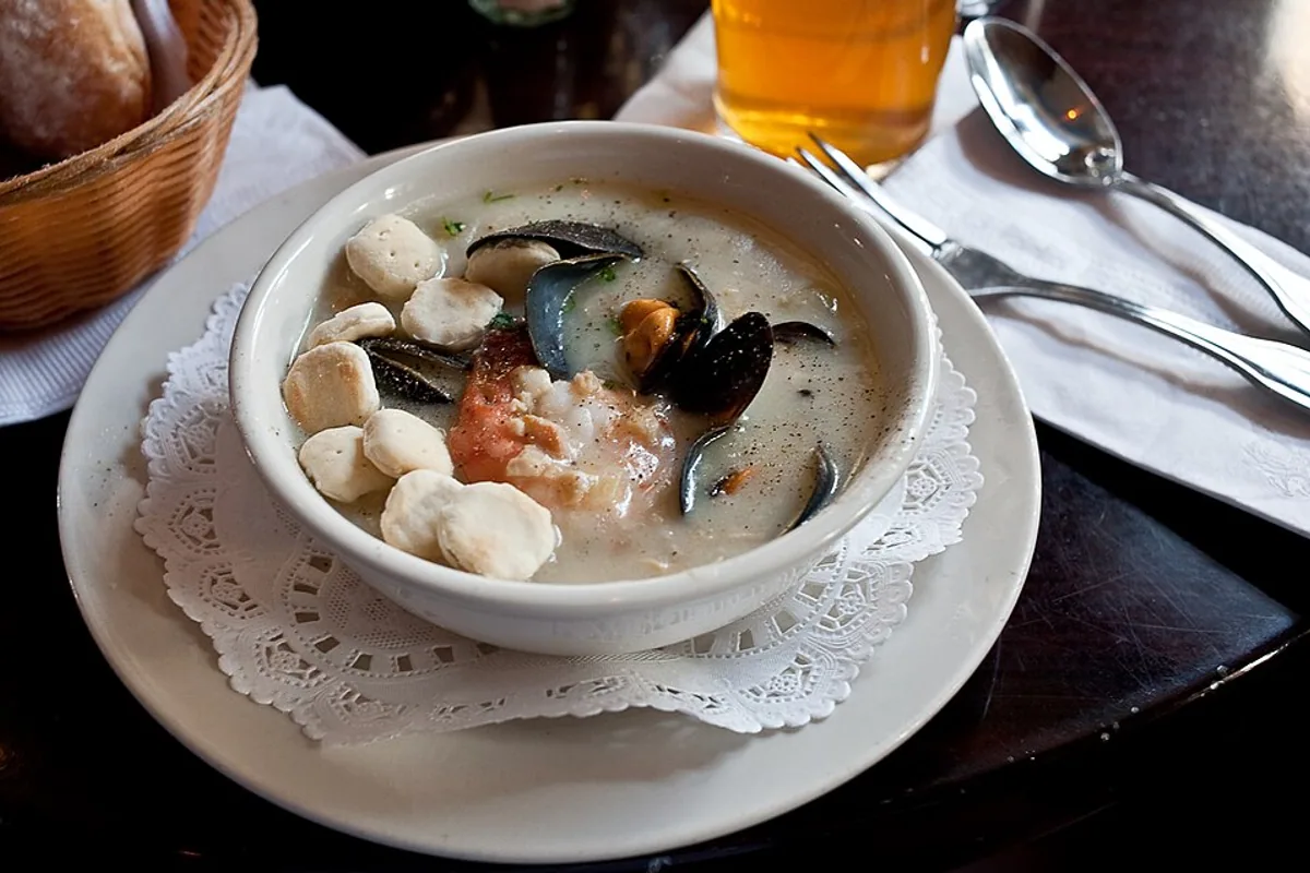 Creamy seafood chowder with fish shellfish mushrooms and herbs