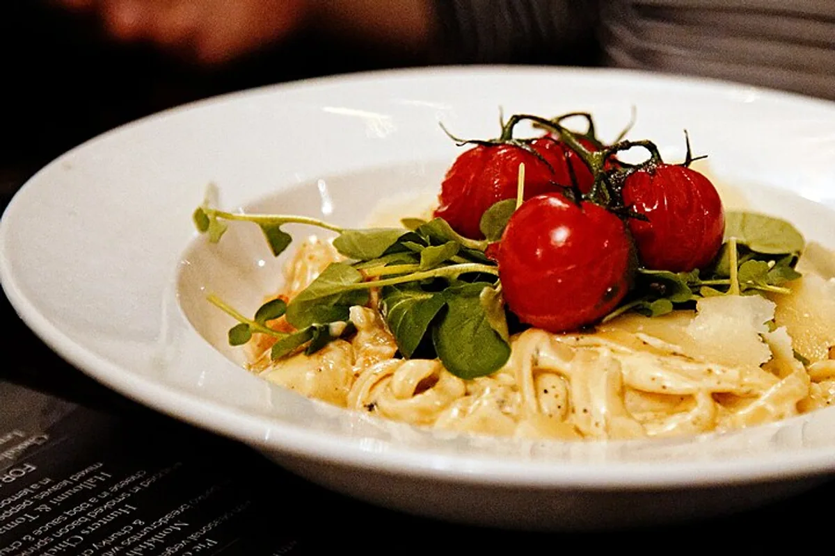 Seafood linguine with cherry tomatoes arugula garlic and herbs