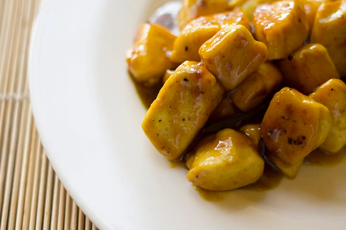 Bite-size chicken in glossy honey mustard and turmeric sauce