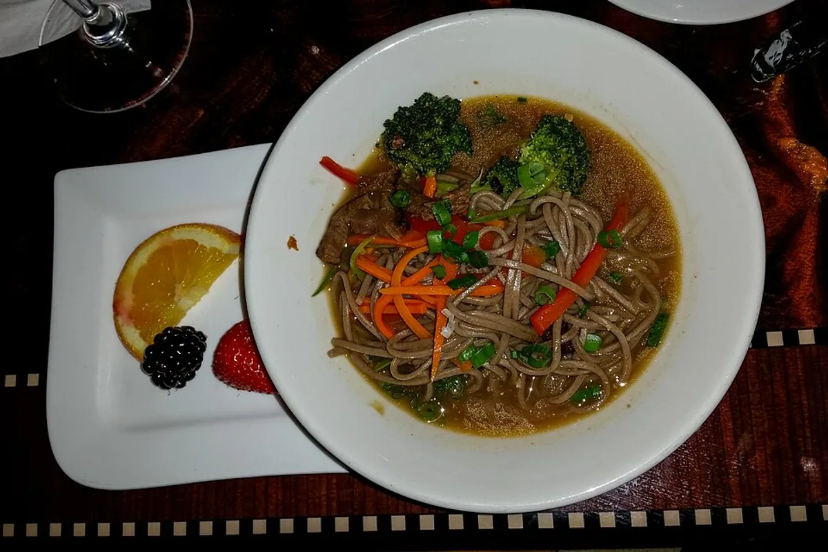 Soba noodle bowl with scallions carrots broccoli and sesame dressing