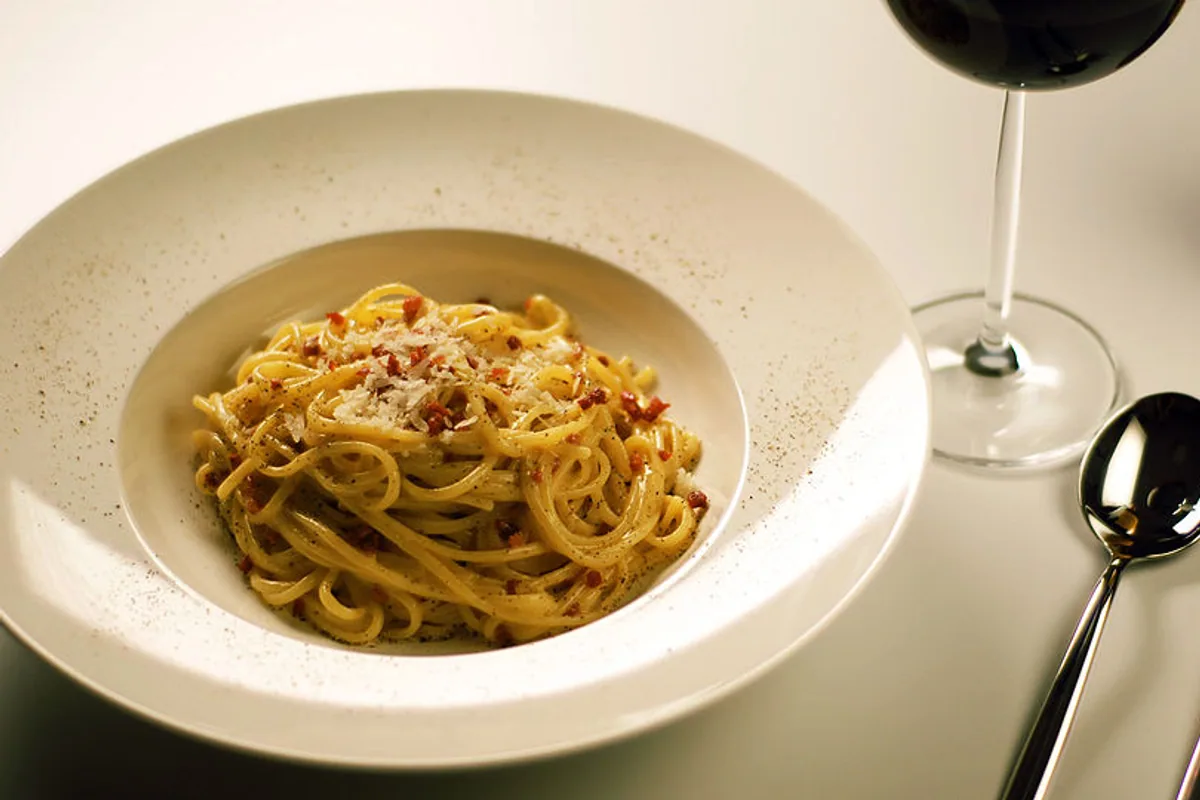 Spaghetti carbonara with crisp pork grated Pecorino and black pepper