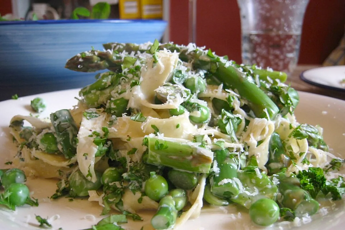 Tagliatelle with asparagus peas fava beans herbs and grated Parmesan
