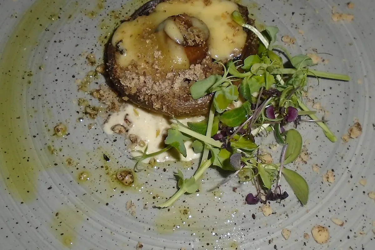 Stuffed portobello mushroom with chestnut blue cheese walnut crumb creamed leeks and greens