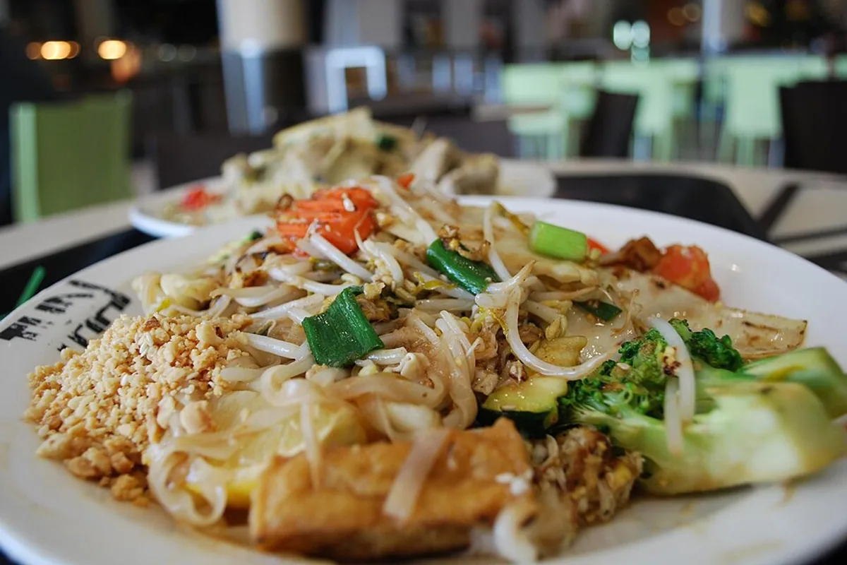 Tofu and vegetable pad Thai with rice noodles crushed peanuts lime and herbs
