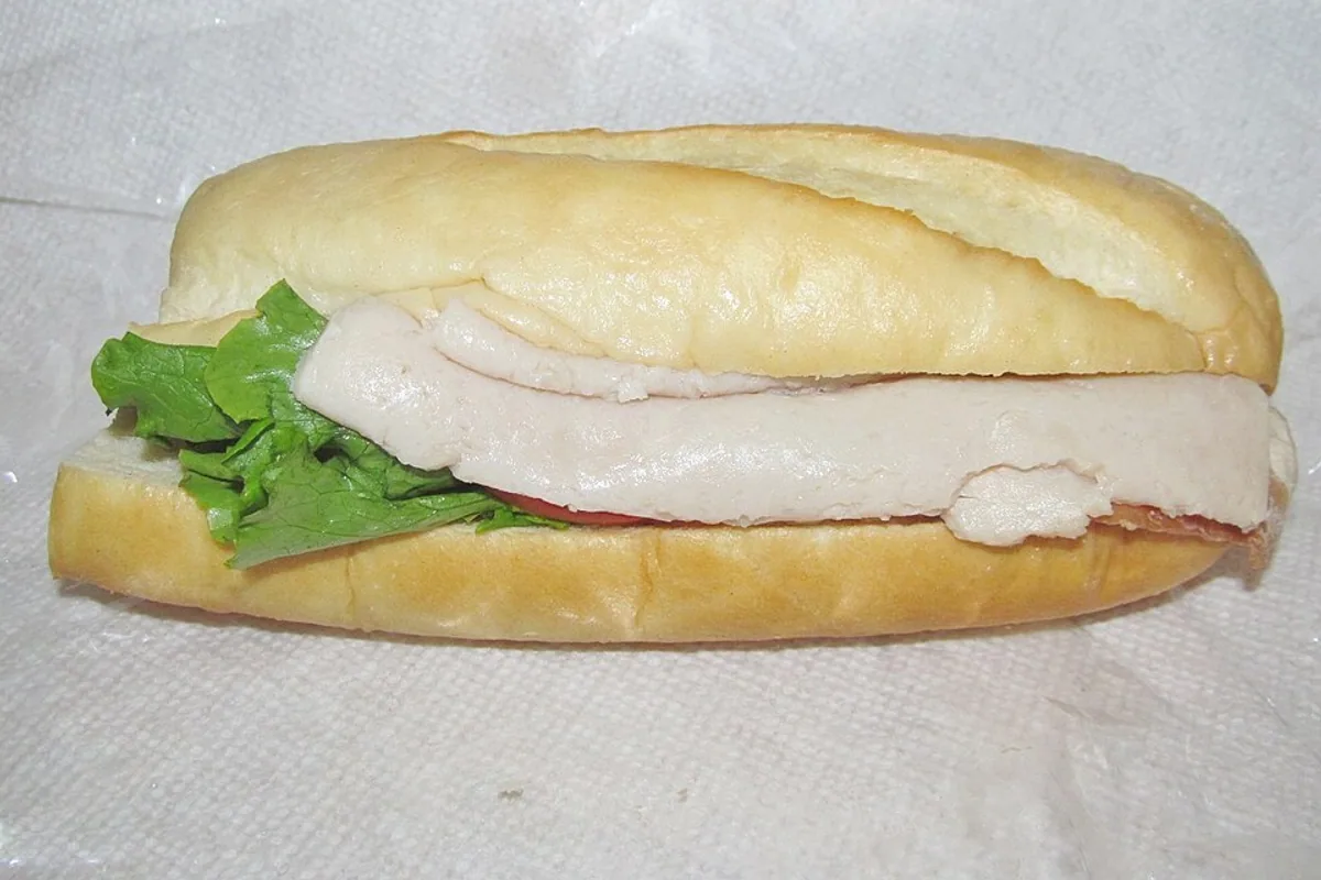 Turkey club hoagie with sliced turkey bacon tomato and green leaf lettuce