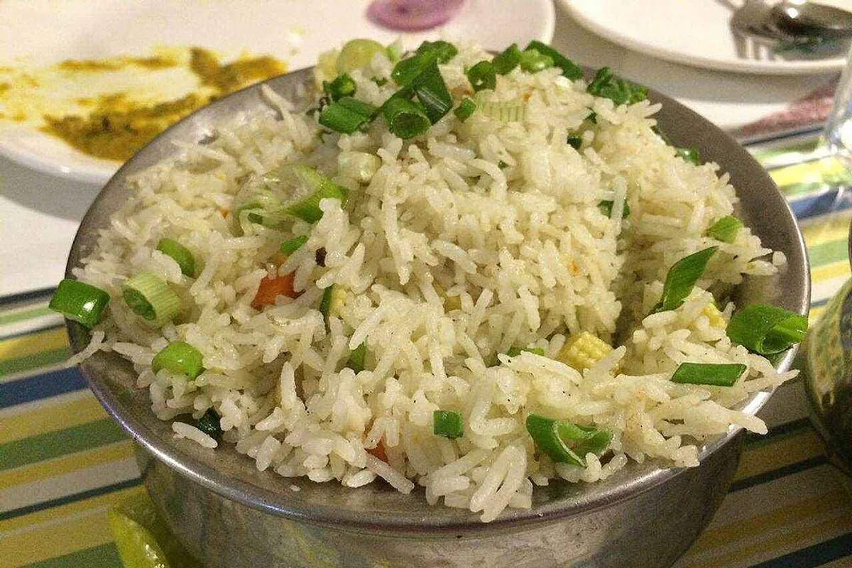 Vegetable biryani with basmati rice peas carrots herbs and fried onion