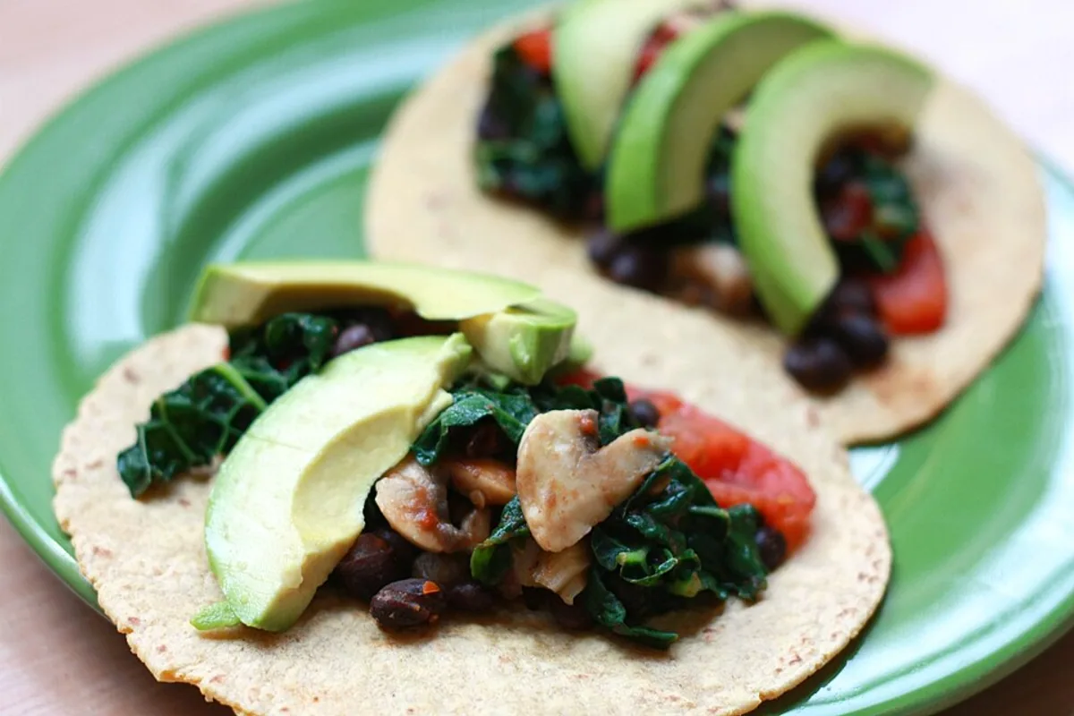 Vegetable and black bean tacos with avocado radish cilantro and lime