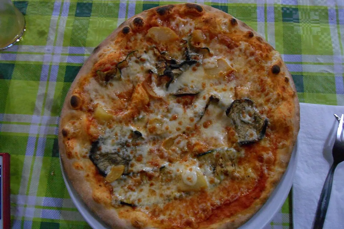 Whole vegetable pizza with roasted zucchini yellow pepper tomato sauce and cheese