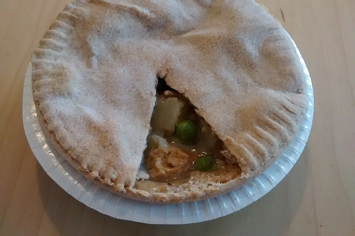 Individual vegetable pot pie with a browned flaky pastry crust