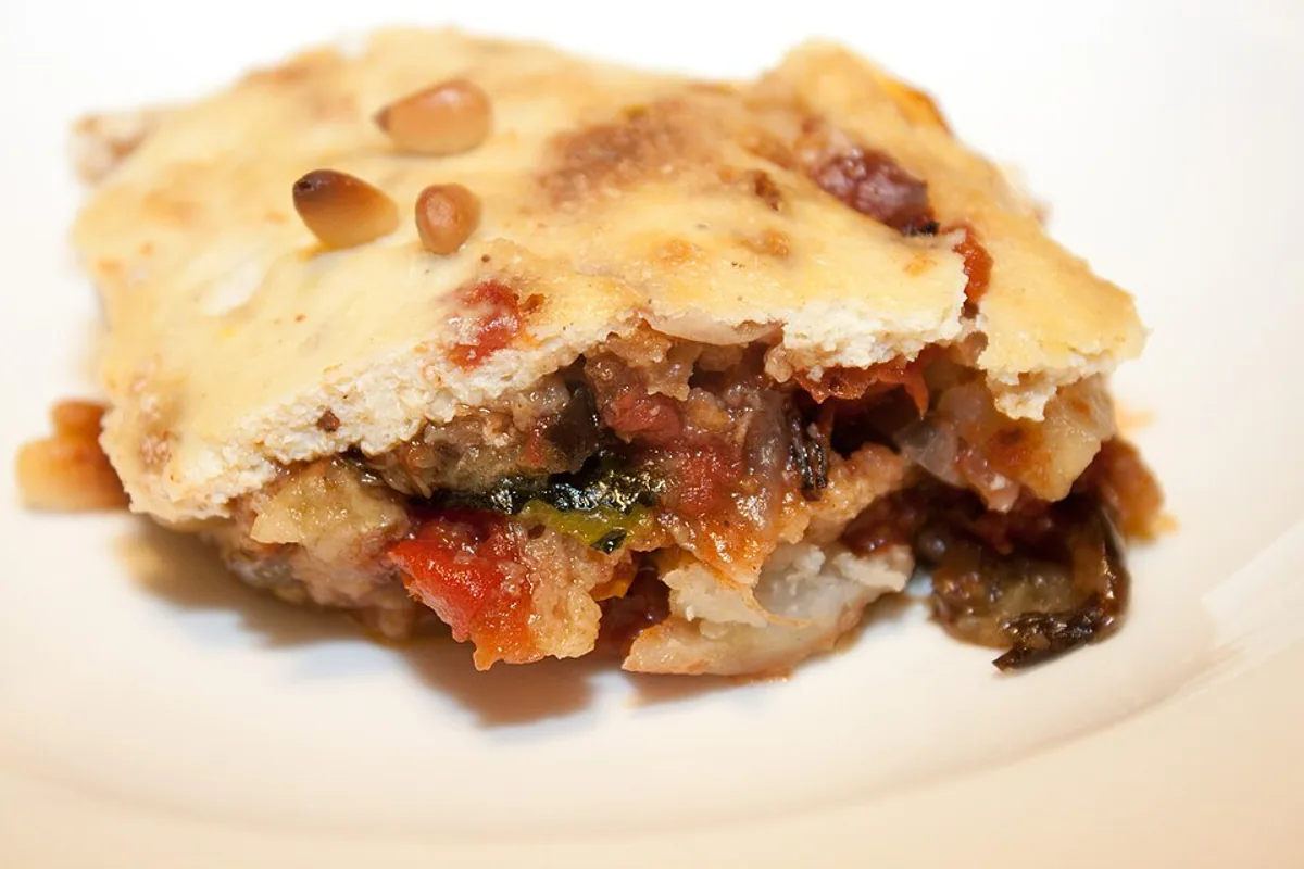 Vegetarian moussaka slice with eggplant potato tomato sauce and creamy baked topping