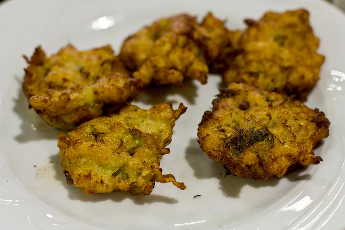 Golden zucchini fritters flecked with herbs and vegetables
